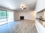 Thumbnail 5 of 24 - Huntington Glen living room with fireplace and vaulted ceiling