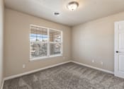 Thumbnail 11 of 29 - A room with a window and a carpeted floor.