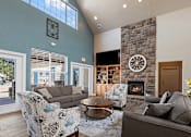 Thumbnail 17 of 29 - A living room with a fireplace and a couch.