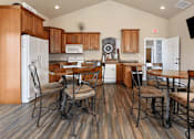 Thumbnail 18 of 29 - A kitchen with wooden cabinets and a white refrigerator.