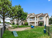 Thumbnail 20 of 29 - A large house with a green lawn and a slide in the yard.