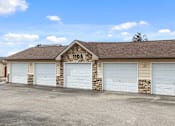 Thumbnail 23 of 29 - A building with the number 1105 on it has four garage doors.