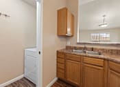 Thumbnail 3 of 29 - A bathroom with a white cabinet and a brown counter.