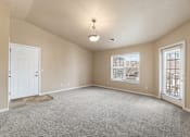 Thumbnail 7 of 29 - A room with a carpeted floor and a ceiling light.