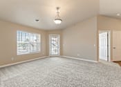 Thumbnail 8 of 29 - A spacious room with a carpeted floor and a ceiling light.