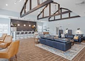 Thumbnail 21 of 38 - A modern living room with a blue couch and a wooden floor.