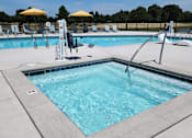 Thumbnail 26 of 38 - A pool with a diving board and sun loungers.