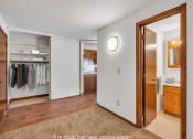 Thumbnail 12 of 22 - a bathroom with a mirror and a closet with clothes