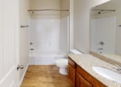 Thumbnail 8 of 16 - a bathroom with a toilet and a shower and a sink
