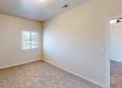 Thumbnail 5 of 16 - an empty living room with a window and carpet