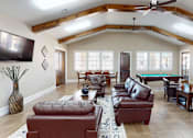 Thumbnail 12 of 30 - A living room with a pool table and leather furniture.