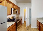 Thumbnail 2 of 16 - a kitchen with a stove and a refrigerator