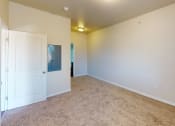 Thumbnail 3 of 16 - a bedroom with a white door and a carpeted floor