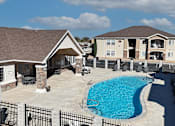 Thumbnail 20 of 30 - A swimming pool in a backyard with a house in the background.