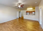 Thumbnail 6 of 16 - an empty living room and kitchen with a ceiling fan