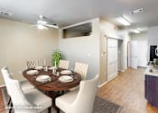 Thumbnail 2 of 25 - A dining room with a round table set for six.