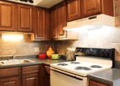 Thumbnail 3 of 17 - fully equipped kitchen with a stove and a sink