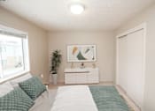 Thumbnail 7 of 23 - a bedroom with a large bed next to a window