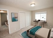 Thumbnail 9 of 23 - a bedroom with a bed and a desk