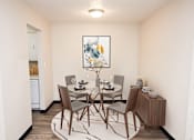 Thumbnail 5 of 23 - a dining room with a table and chairs and a painting on the wall
