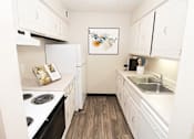 Thumbnail 2 of 23 - a kitchen with white cabinets and appliances