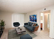 Thumbnail 3 of 23 - a living room with a couch and a coffee table