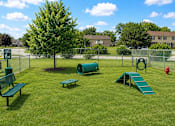 Thumbnail 16 of 20 - A playground with a slide, bench, and a tree.