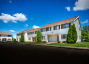 Thumbnail 12 of 14 - Building exterior with landscaping at indian woods apartments