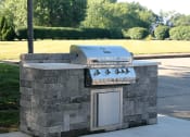 Thumbnail 7 of 14 - a stone outdoor kitchen with a grill in a park