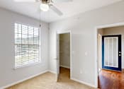Thumbnail 5 of 27 - A room with a ceiling fan and a window with blinds.