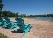 Thumbnail 12 of 23 - a group of blue chairs sitting on the beach