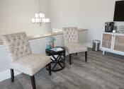 Thumbnail 6 of 23 - a leasing office with two chairs and a table
