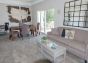 Thumbnail 7 of 23 - a clubhouse area with a couch and a table