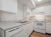 Thumbnail 12 of 29 - kitchen with white appliances and Granite-Style Countertops