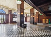 Thumbnail 9 of 29 - the lobby of a building with a checkered floor and columns