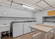 Thumbnail 18 of 25 - a kitchen with white appliances and a table