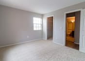Thumbnail 5 of 35 - A room with a carpeted floor and a window.