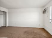 Thumbnail 8 of 15 - an empty room with Air Conditioning on the wall