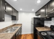 Thumbnail 1 of 15 - a kitchen with black appliances and granite counter tops