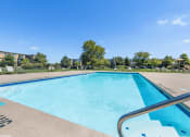 Thumbnail 9 of 15 - swimming pool with apartment buildings in the background