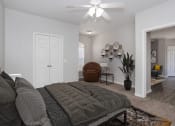 Thumbnail 7 of 33 - a bedroom with a bed and a ceiling fan