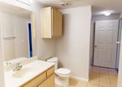 Thumbnail 13 of 33 - A bathroom with a toilet, sink, and medicine cabinet.