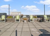 Thumbnail 9 of 15 - the roof terrace has several chairs and plants on it