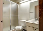 Thumbnail 17 of 24 - A white toilet sits in a bathroom next to a sink.