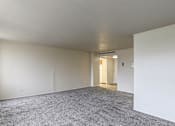 Thumbnail 9 of 24 - A room with a grey carpet and white walls.