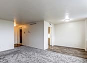 Thumbnail 4 of 24 - A room with a grey carpet and wooden floors.