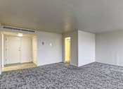 Thumbnail 6 of 24 - A room with a carpeted floor and two doors, one of which is open.