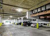 Thumbnail 22 of 24 - A parking garage with cars parked in it.