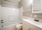 Thumbnail 7 of 25 - A white bathroom with a toilet, sink, and bathtub.