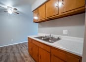 Thumbnail 4 of 25 - A kitchen with a sink and a ceiling fan.